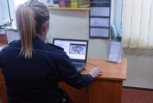 Policjantka, siedząca przed komputerem, na spotkaniach on - line z młodzieżą