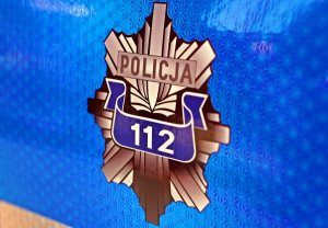 Policyjna gwiazda z napisem Policja i numerem 112