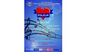 Plakat. na niebieskim tle czerwone serce przeplecione niebieską wstęgą z napisem POLICJA
pod spodem napis Koncert